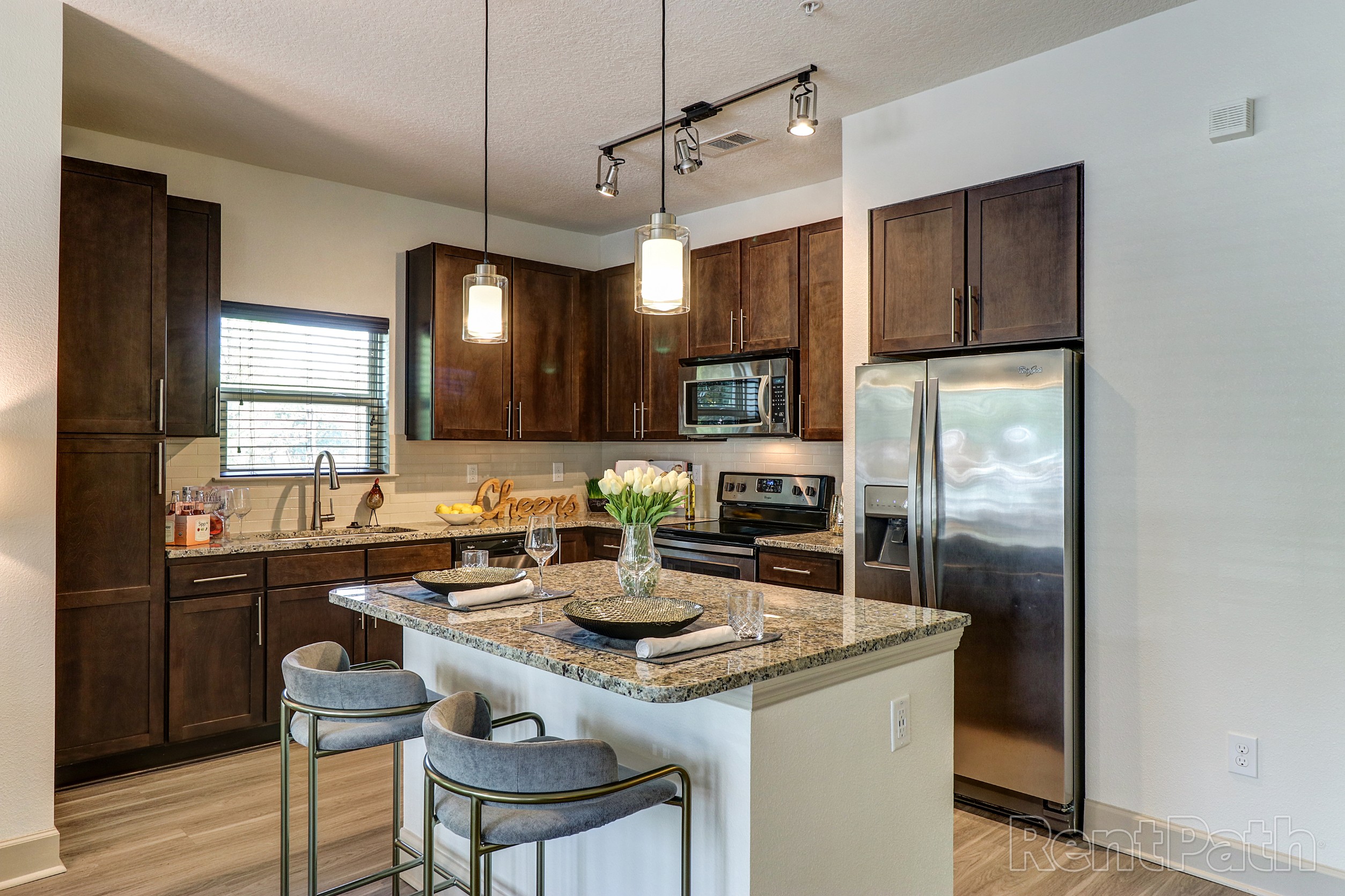 Kitchen with stainless steel appliances and island seating