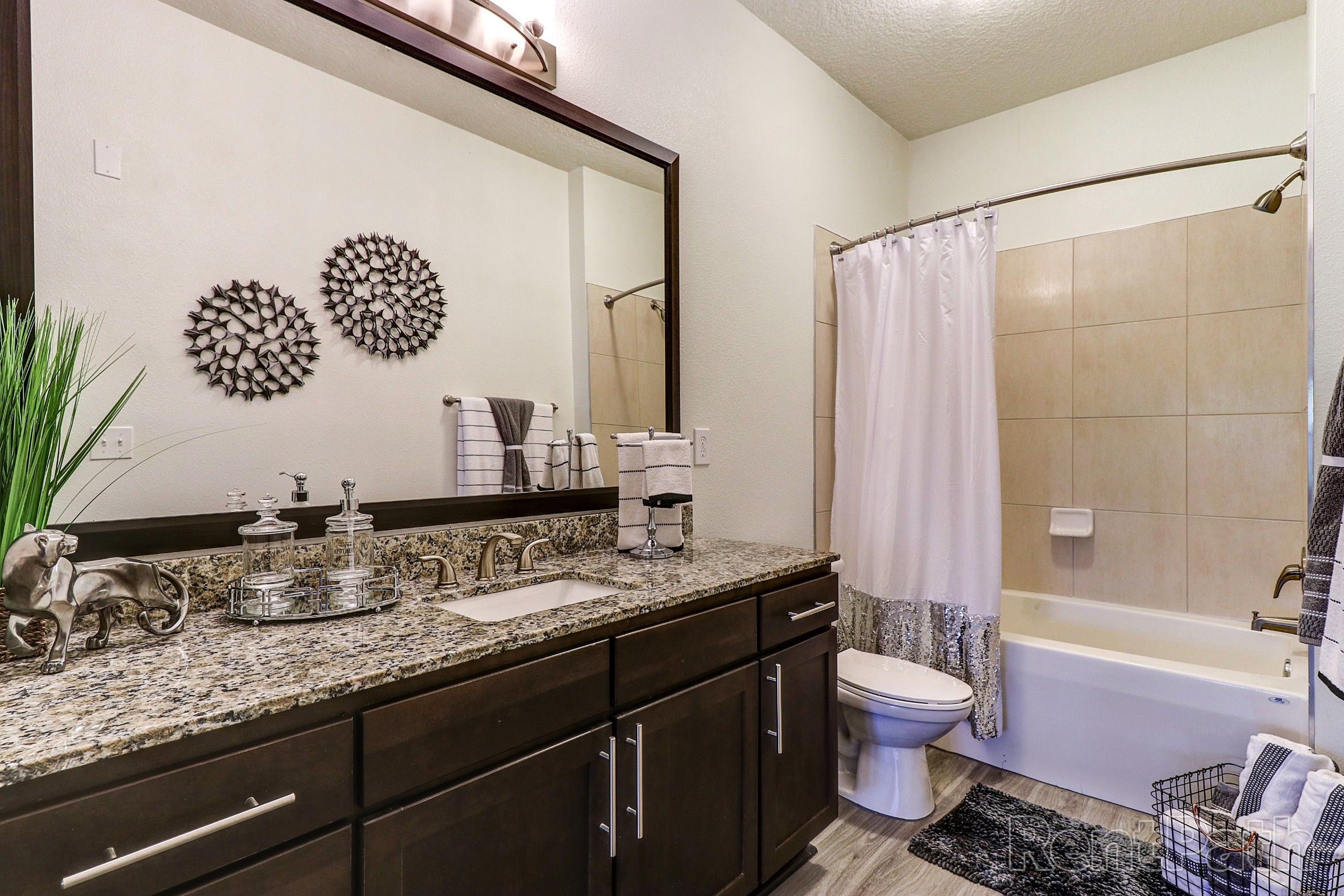 Model bathroom with oversize vanity and tub shower combination