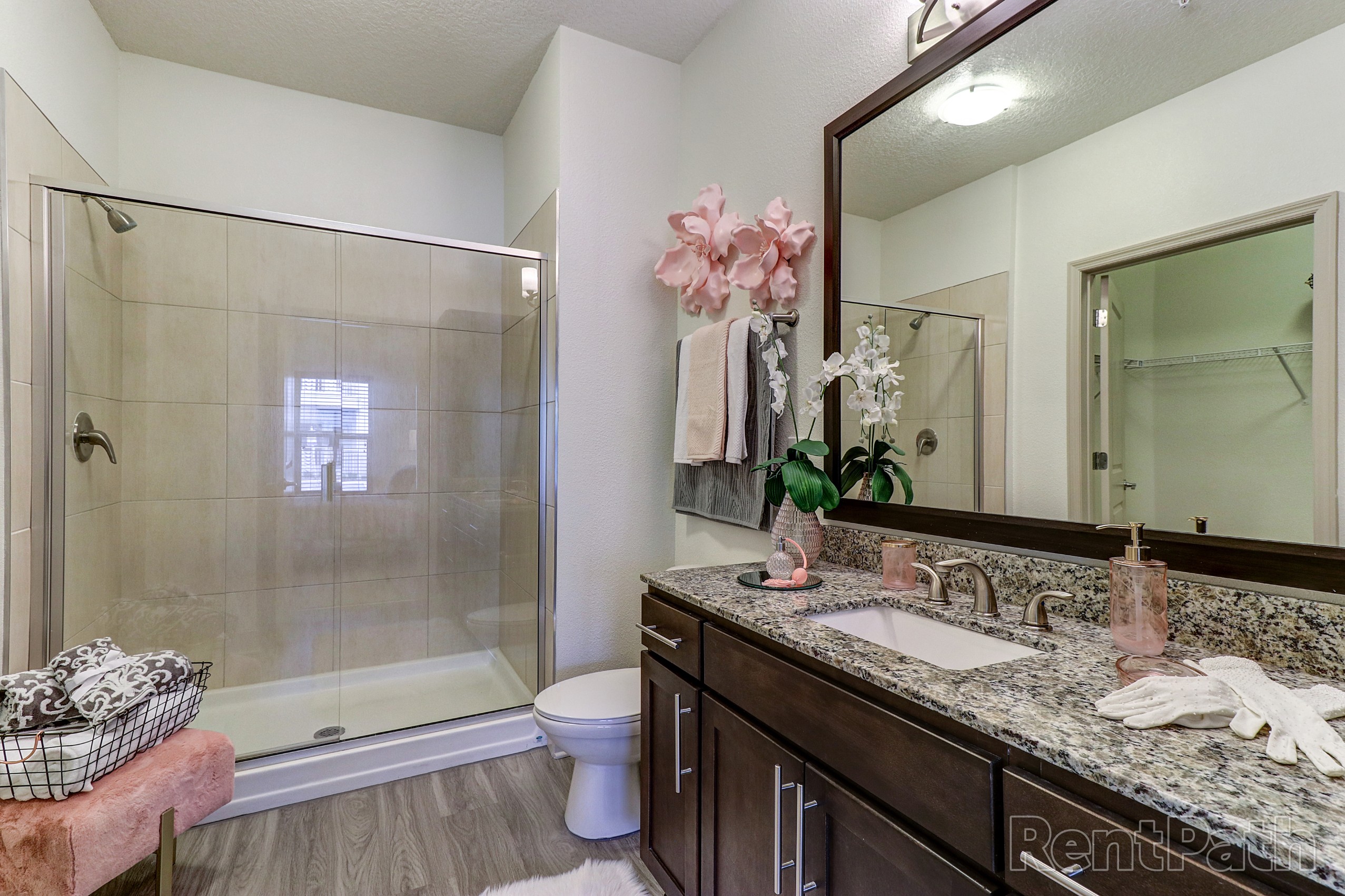 Model bathroom with oversized vanity and granite countertops