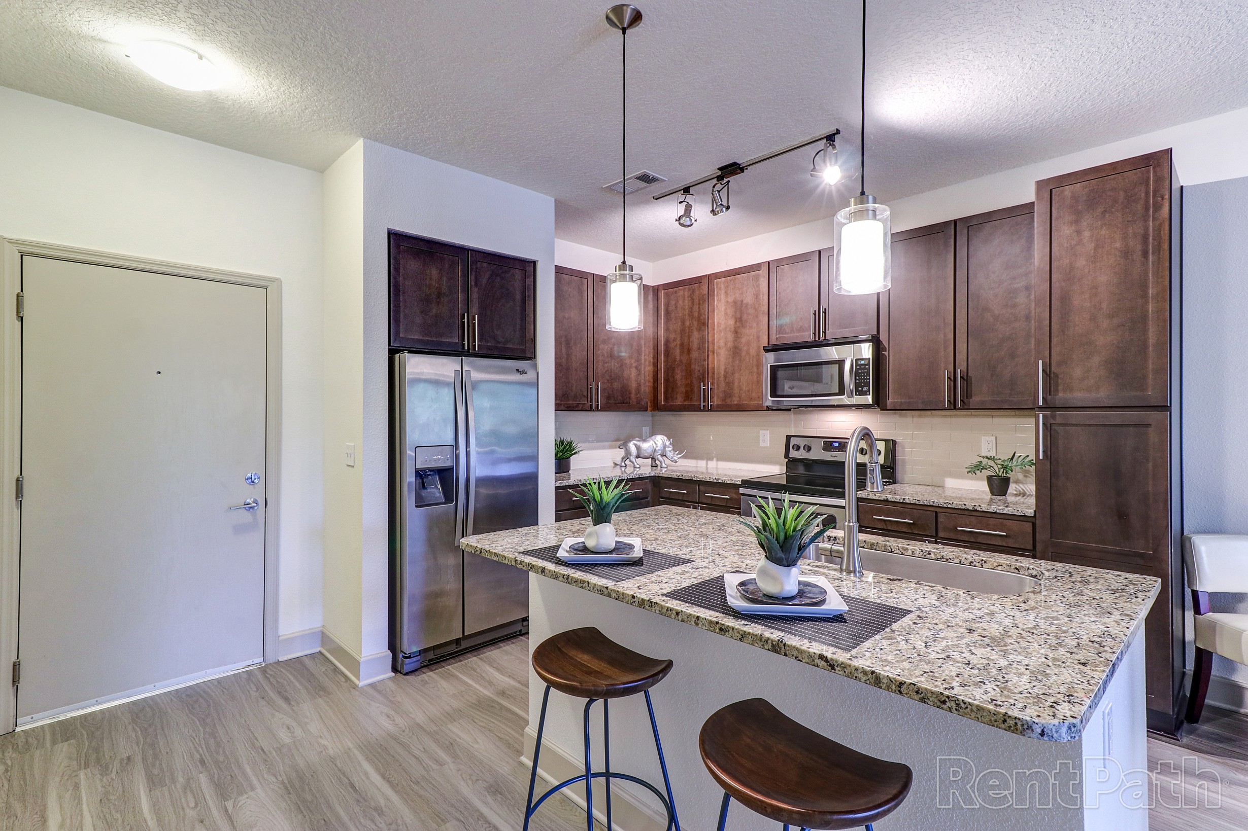 Model kitchen with island and pendant lighting
