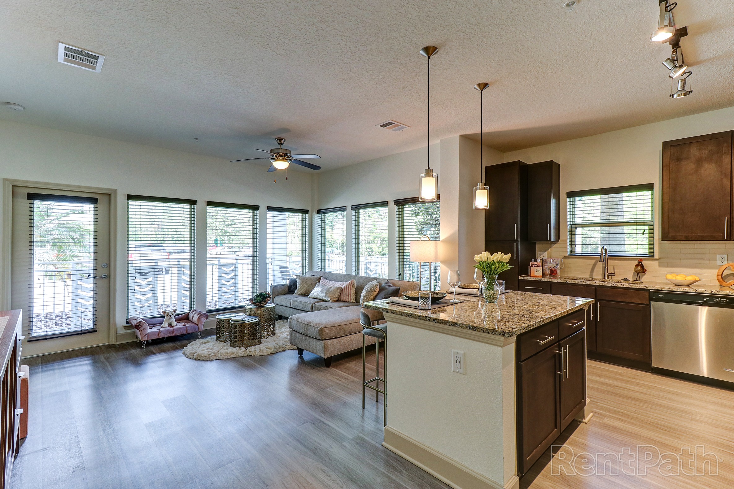 Spacious living area and open kitchen of a model apartment